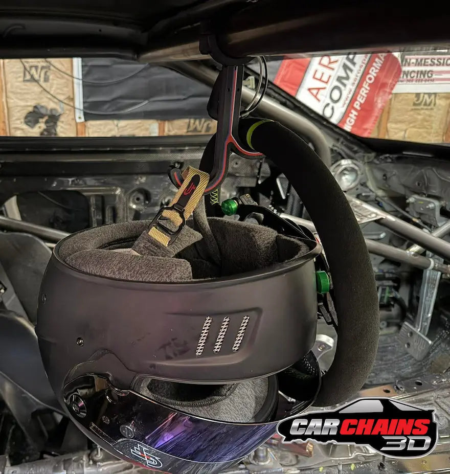 Racing helmet hanging from Car Chains 3D dual hook roll cage helmet holder inside race car with steering wheel visible